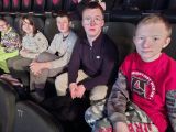 Pięcioro uczniów siedzi w kinie w fotelach z wysokimi oparciami