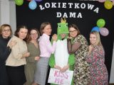 Sześć kobiet stoi obok siebie w rzędzie. Pośród nich stoi chłopak w zielinym przebraniu żaby.