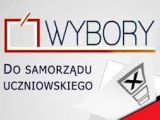 Na szarym tle czarny napis "Wybory do Samorządu Uczniowskiego". W przwym dolnym rogu czerwona urna do głosowania.