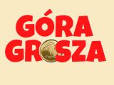 Na kremowym tle czerwony napis "Góra grosza". Pośrodku złota moneta 1 grosz.
